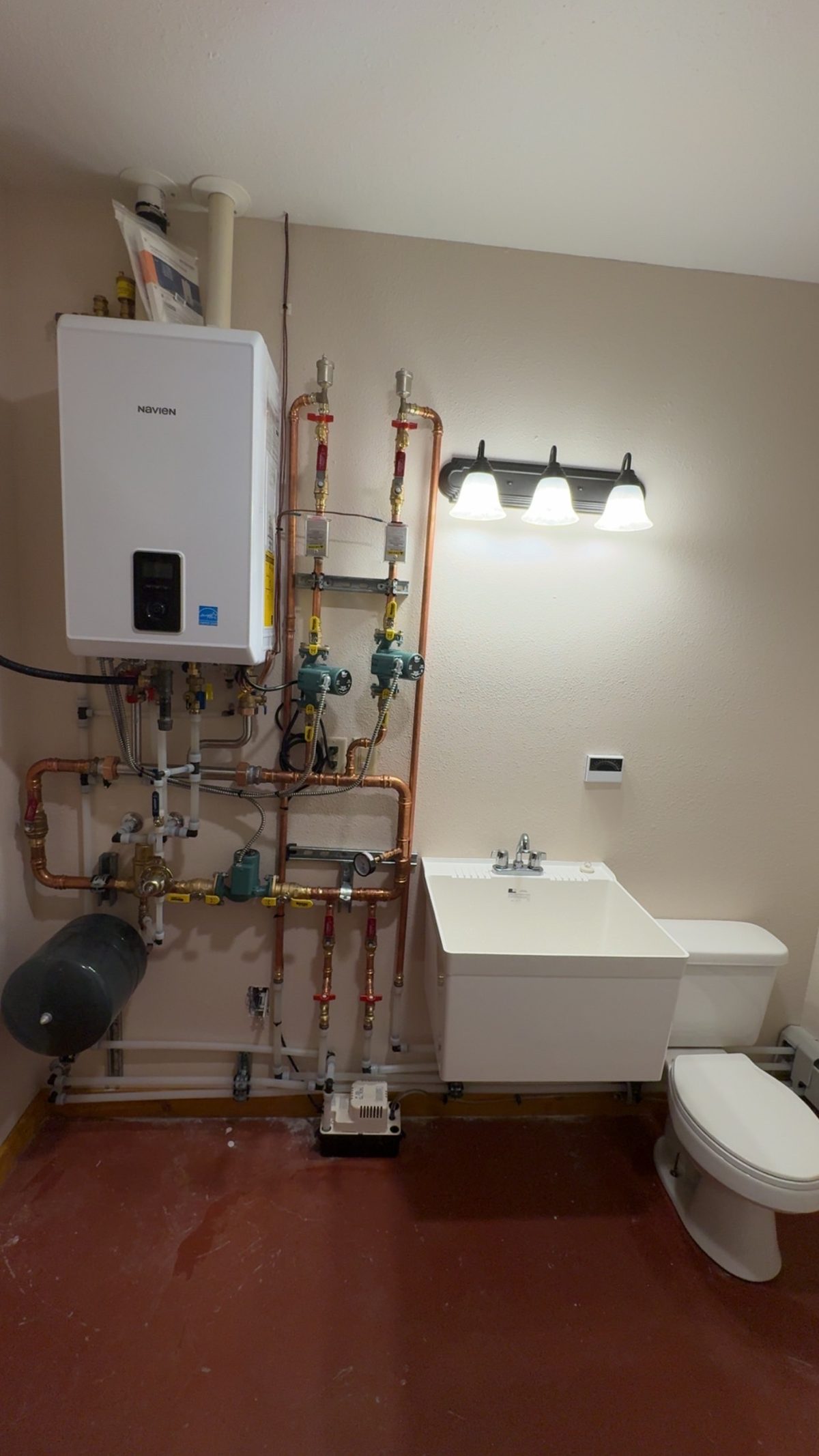Navien boiler system with Taco pumps in utility room installed by Wrangler Plumbing