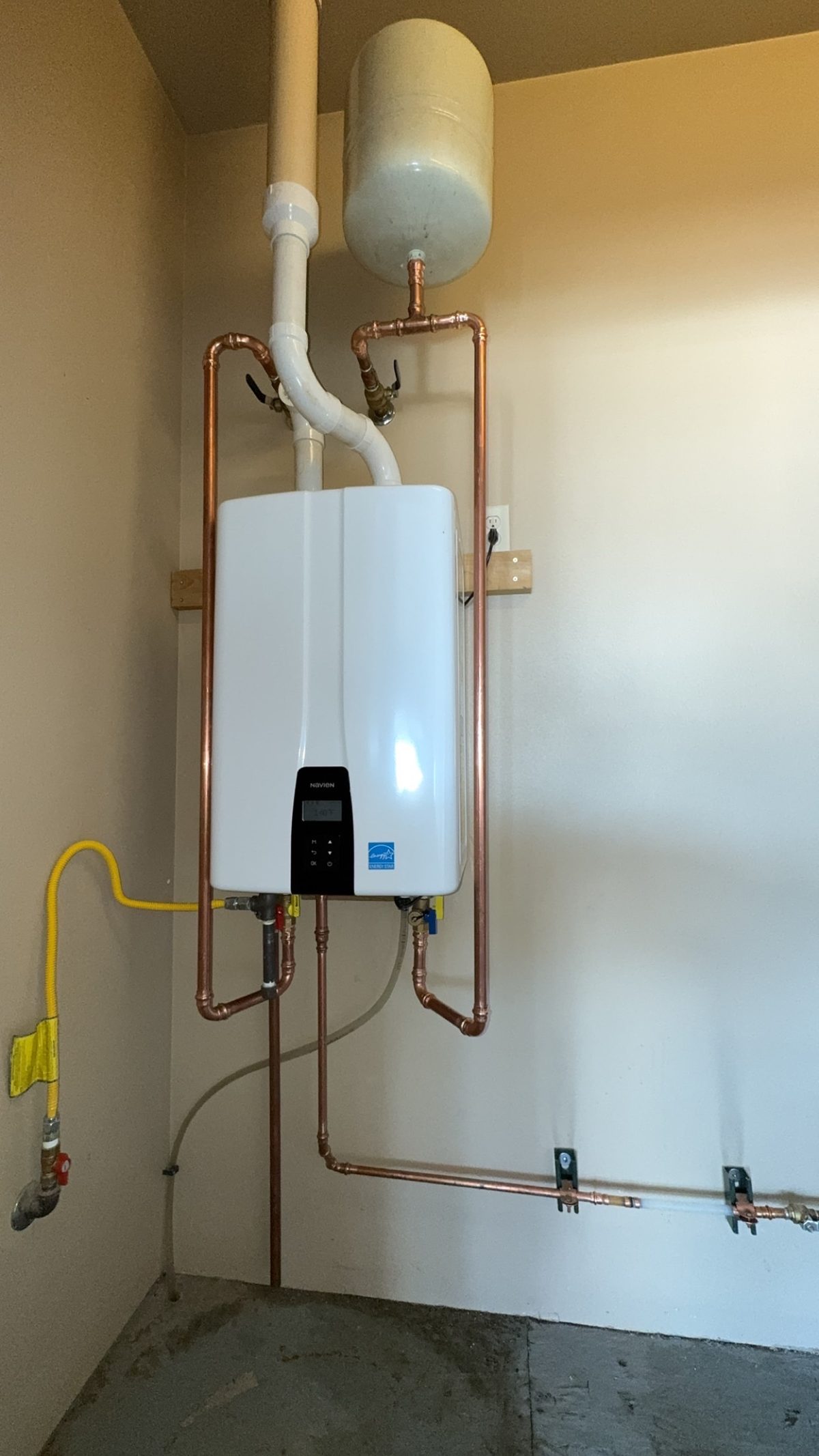Navien tankless water heater with copper piping and expansion tank installed by Wrangler Plumbing