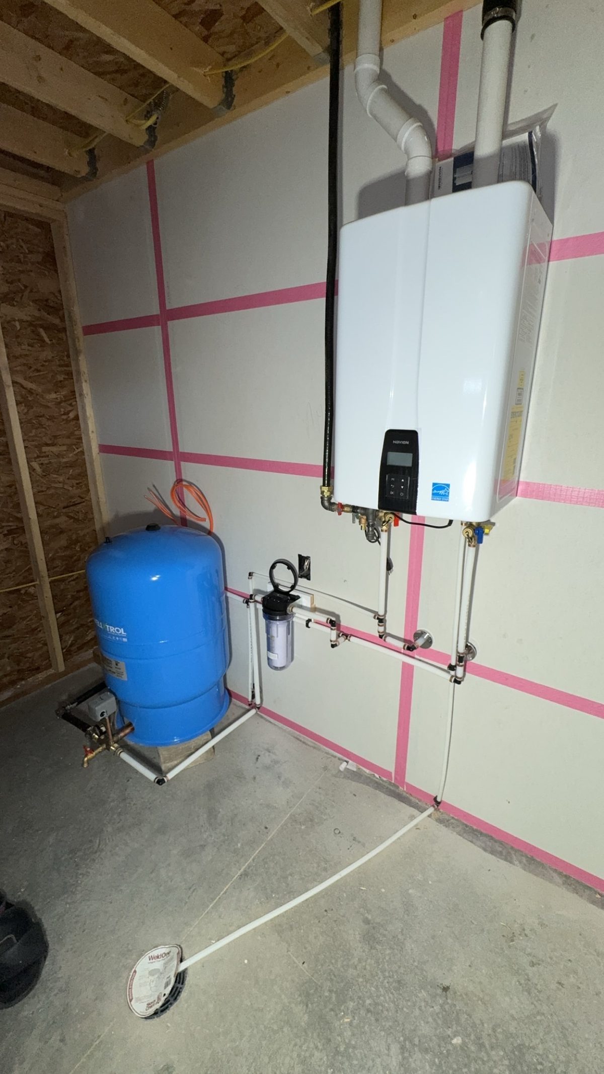 Navien tankless water heater with Well-X-Trol pressure tank installed in new construction home near Cody, Wyoming
